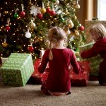 Two Children Opening Gifts On Christmas Morning